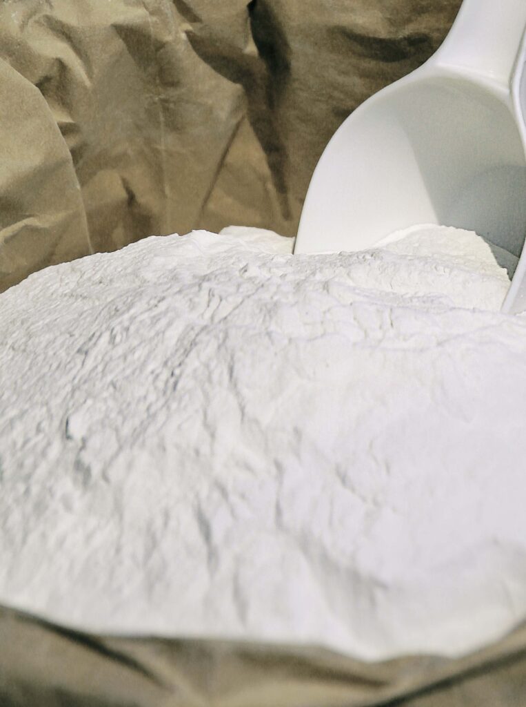 bag of raw material powder with a scooper